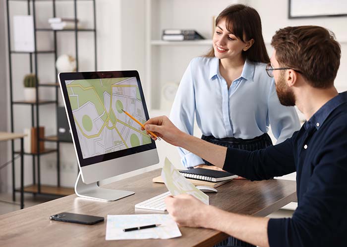 Woman and man looking at property survey