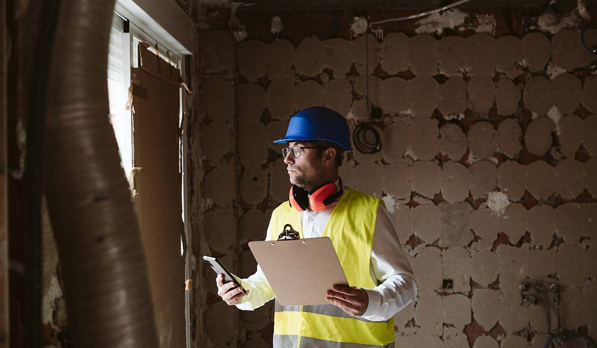 male surveyor inspecting house